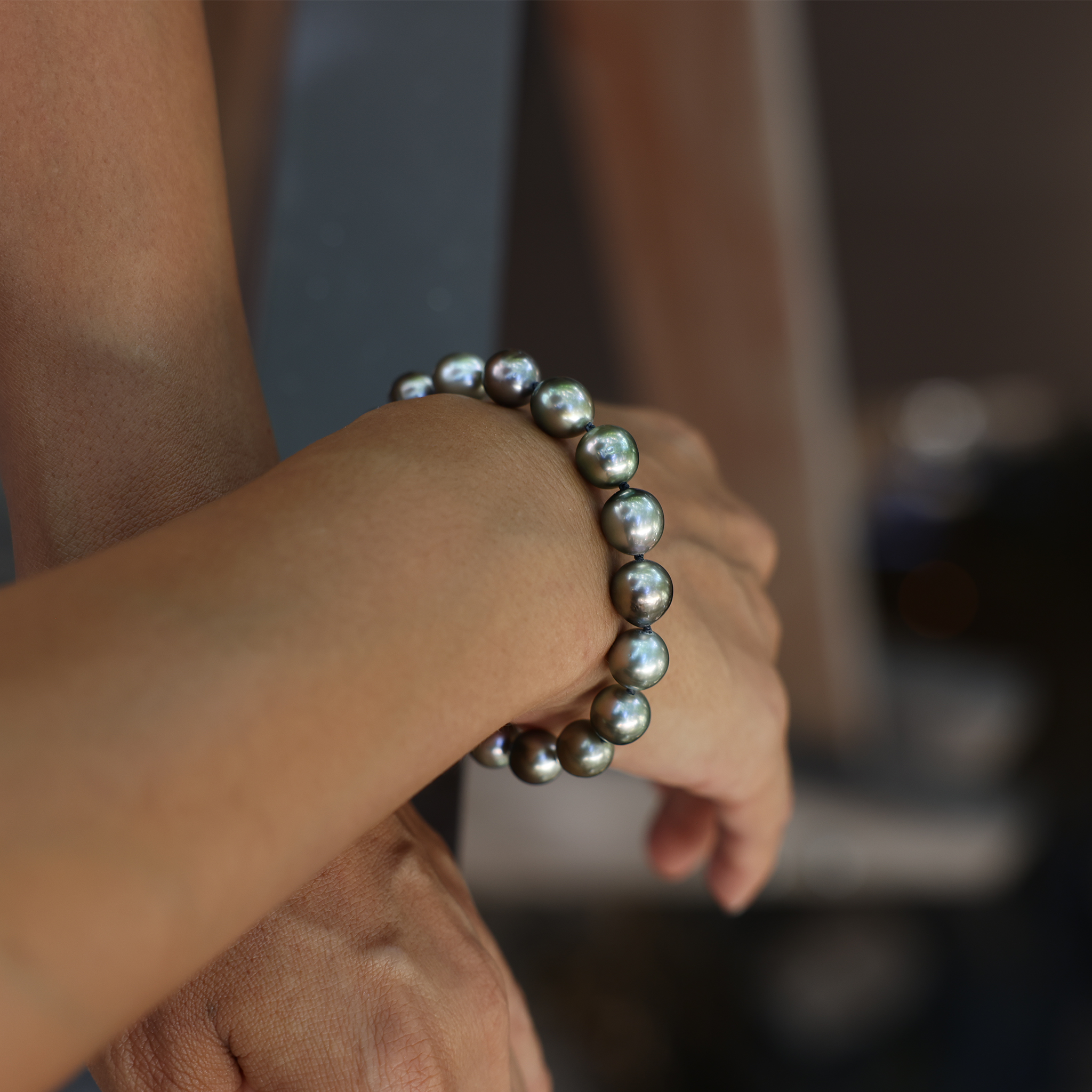 Hand with 7.5-9" Adjustable Tahitian Black Pearl Bracelet in Gold - 8-10mm by Maui Divers Jewelry