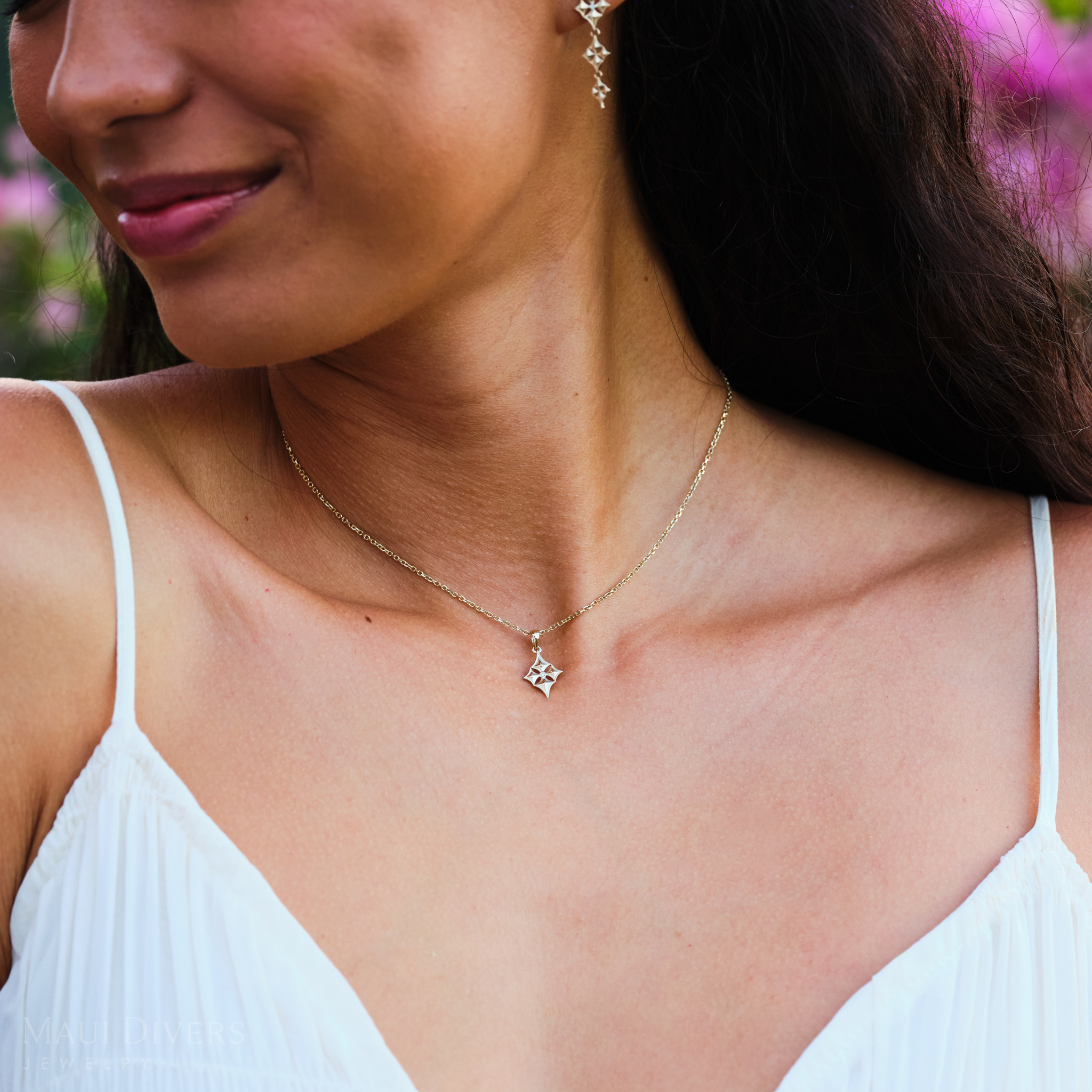 Close-up of woman wearing Hawaiian Quilted Star Pendant in Gold with Diamond on cable chain