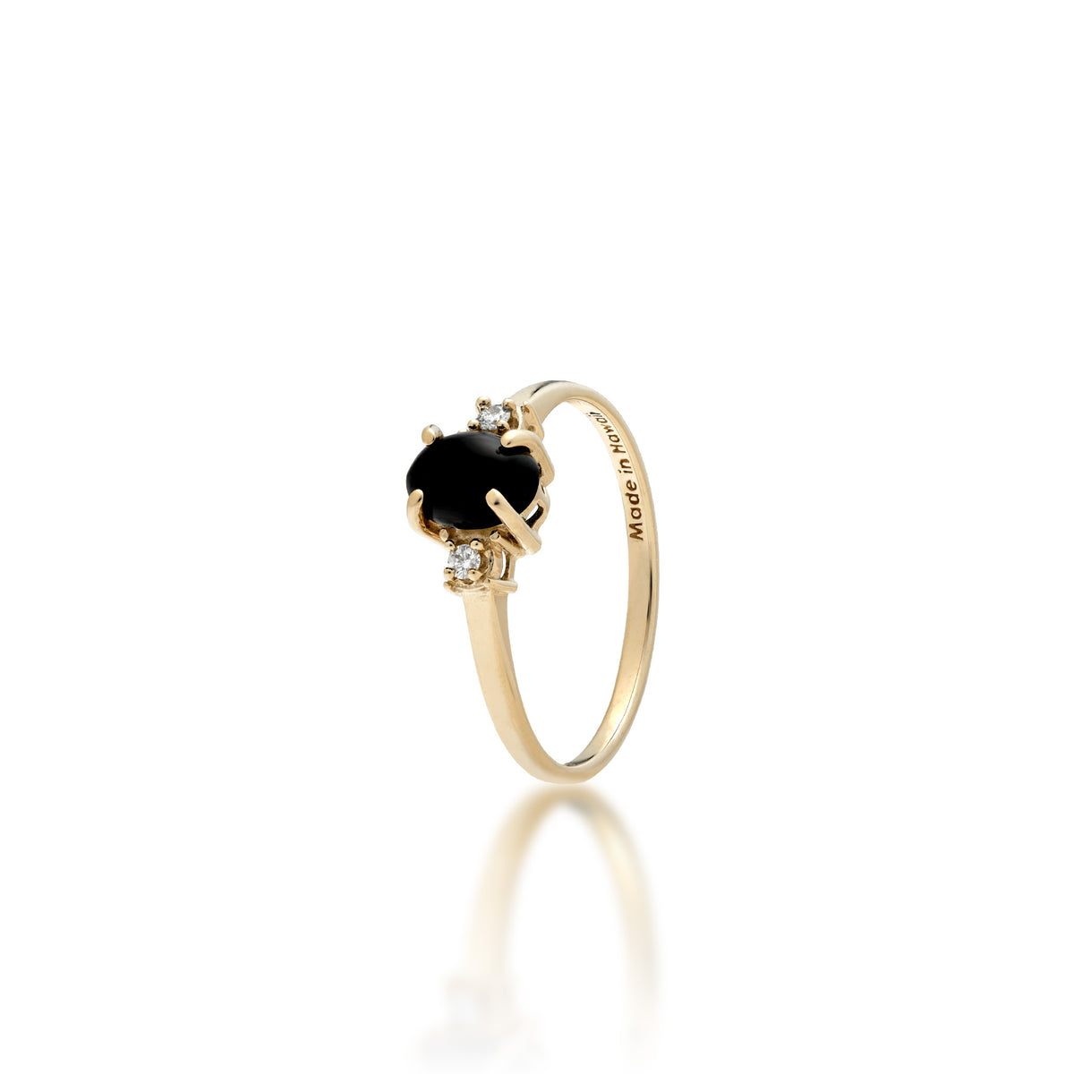 A 14k yellow gold ring with a small oval Hawaiian black coral gem with a diamond accent on each side and 'Made in Hawaii' stamp on the inside of the ring, shown on a white background