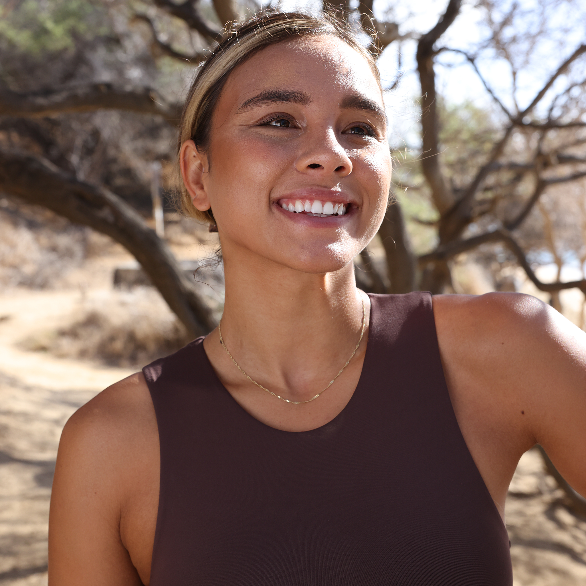Woman at a beach park wearing 1.5mm Singapore Chain in Gold