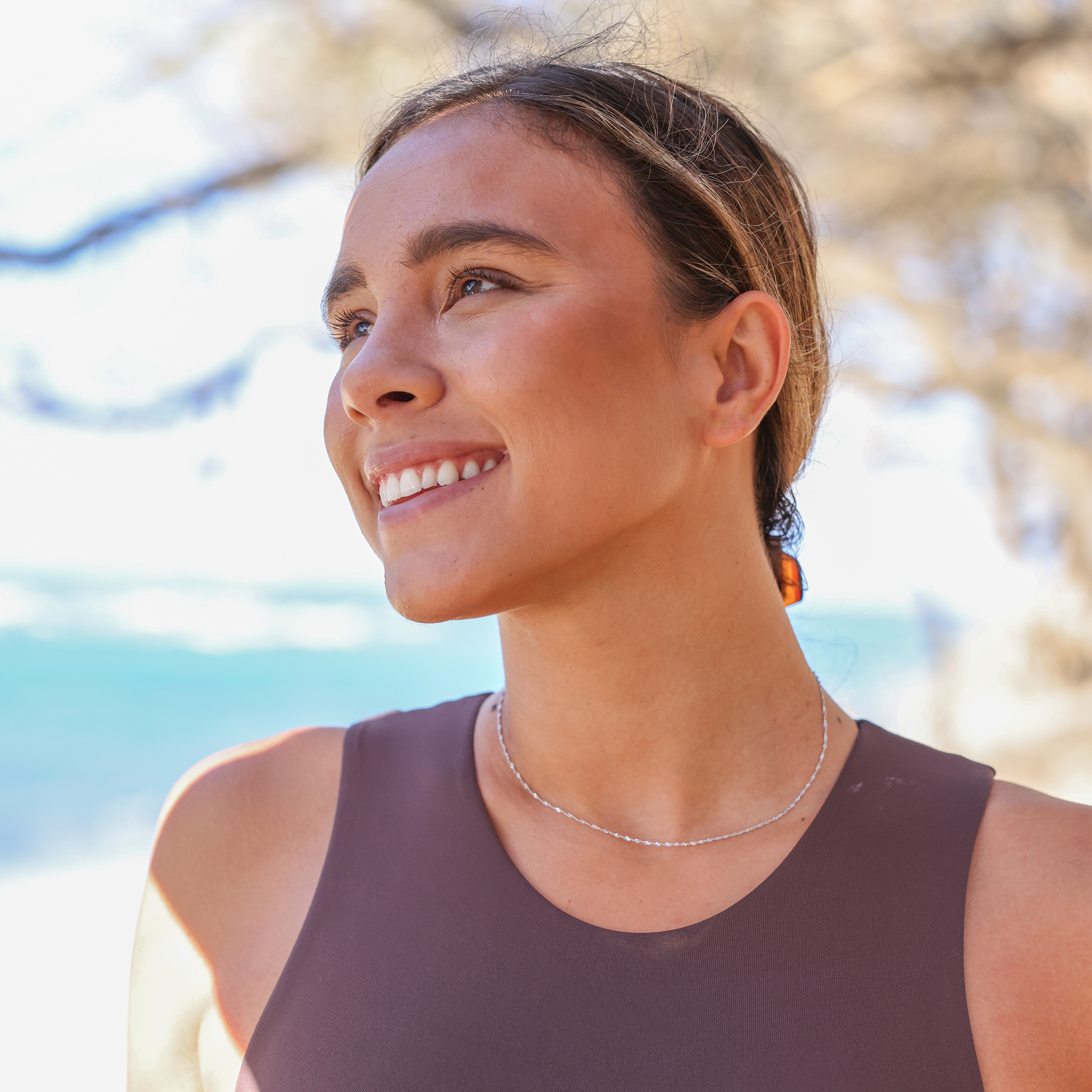 Woman at the beach wearing 1.0mm Singapore Chain in White Gold