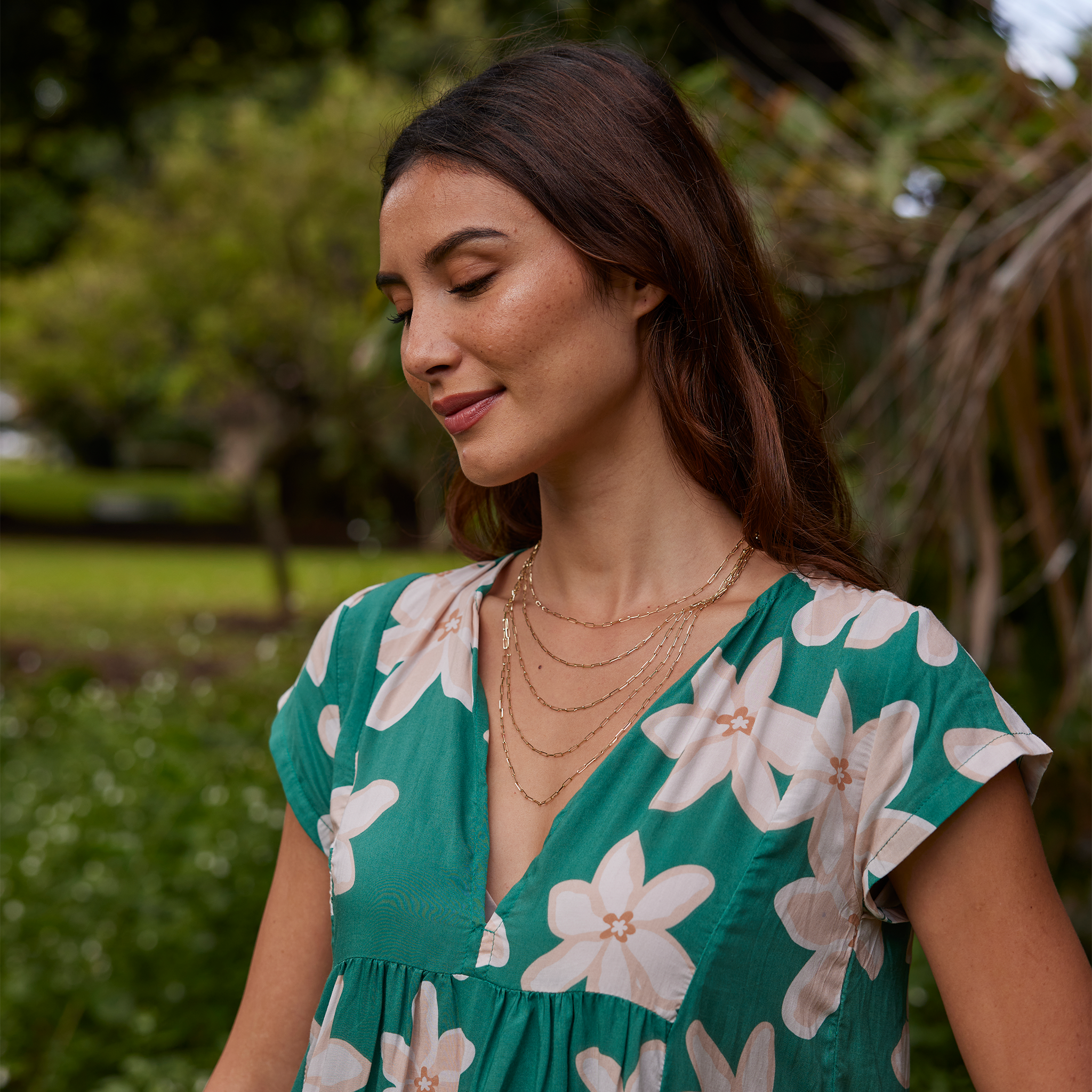 Model in a garden showcaseing 16", 18", 20", 22", and 24" Chain Lengths