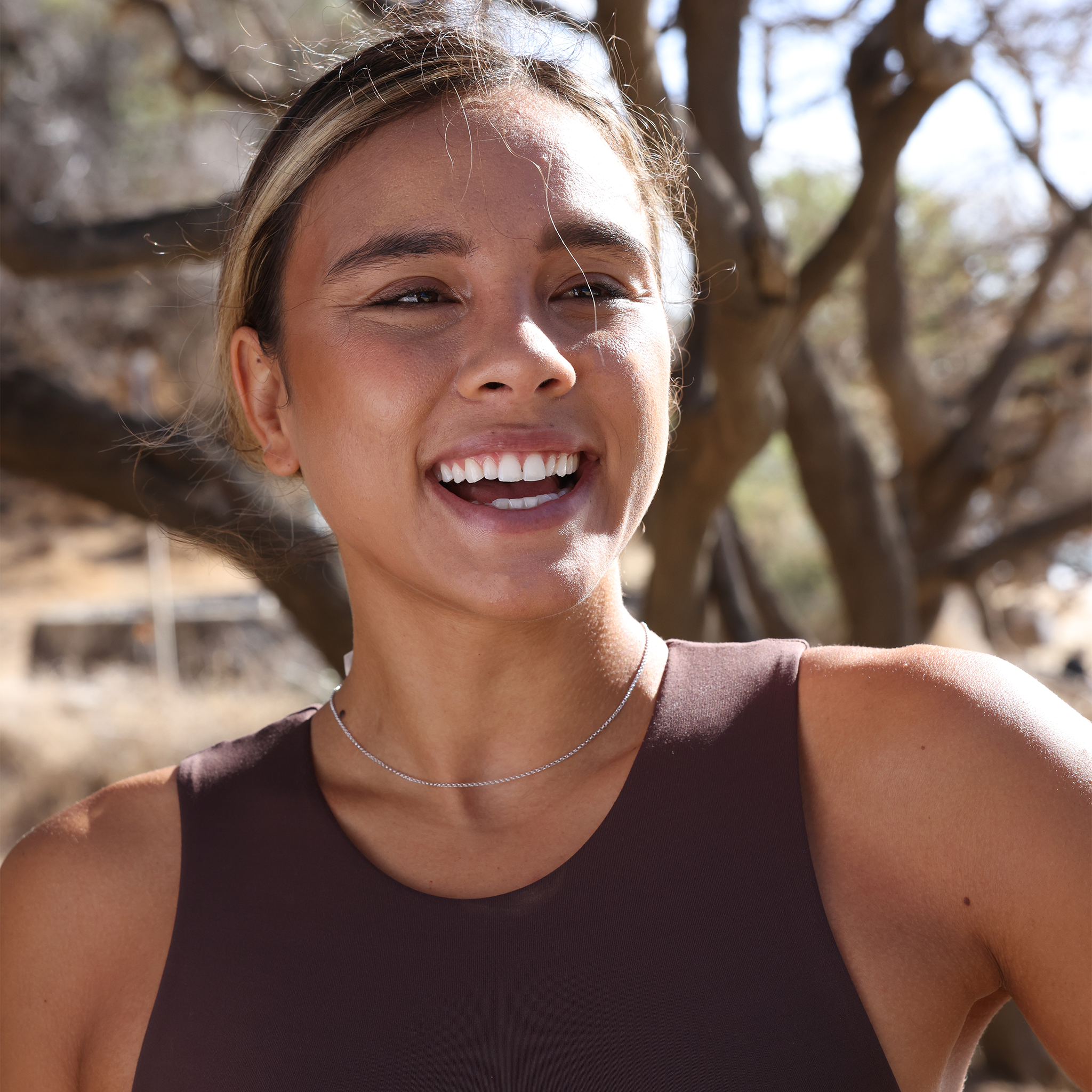 Woman outdoors wearing 1.0mm Rolo Chain in Sterling Silver