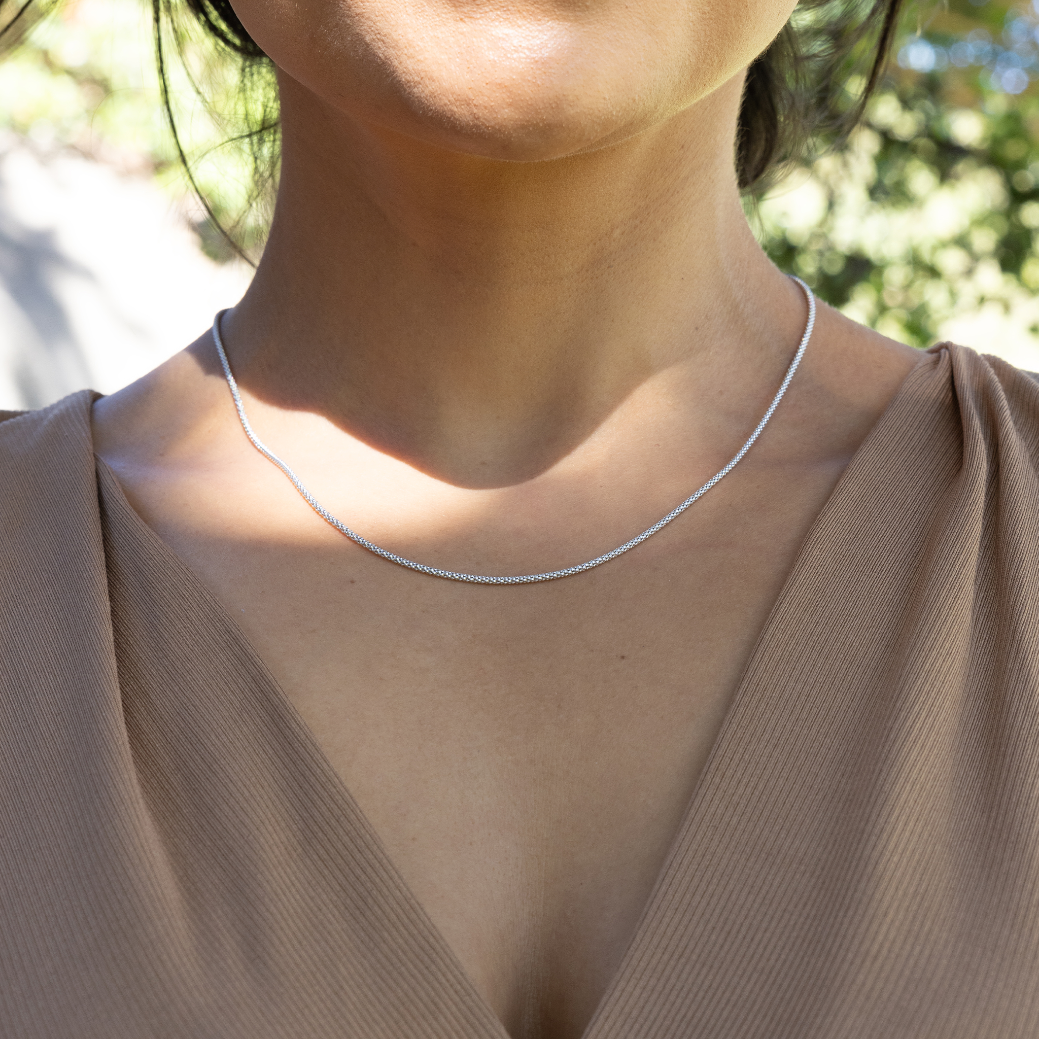 Woman outdoors wearing 1.5mm Popcorn Chain in Sterling Silver