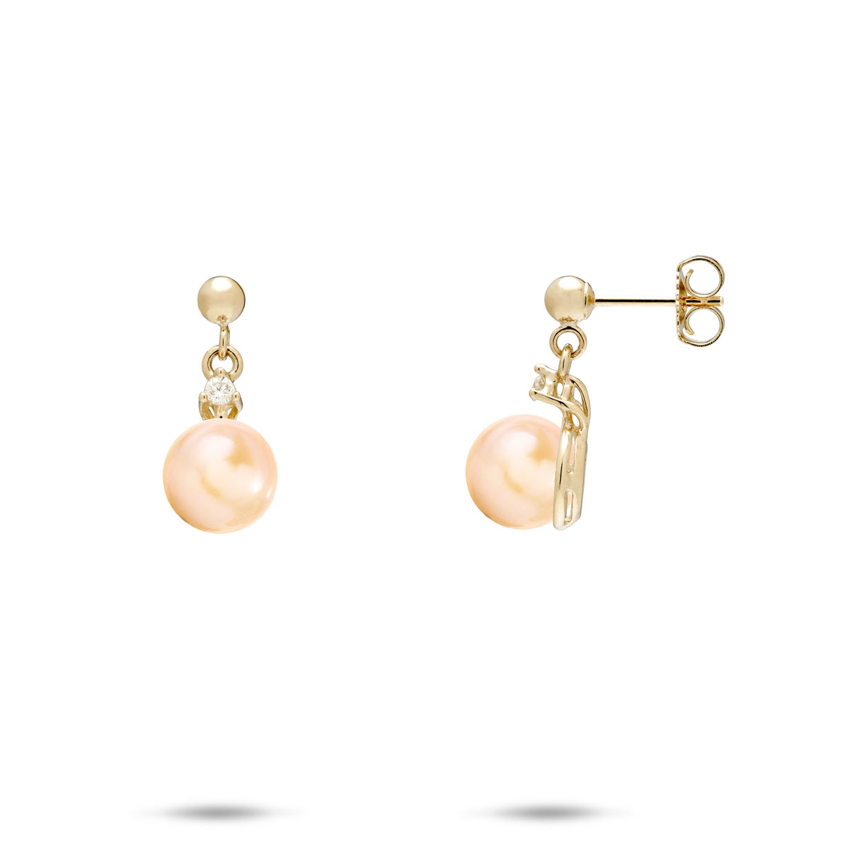 A pair of 14k yellow gold ball-post earrings with a dangling small diamond and peach freshwater pearl, shown on a white background
