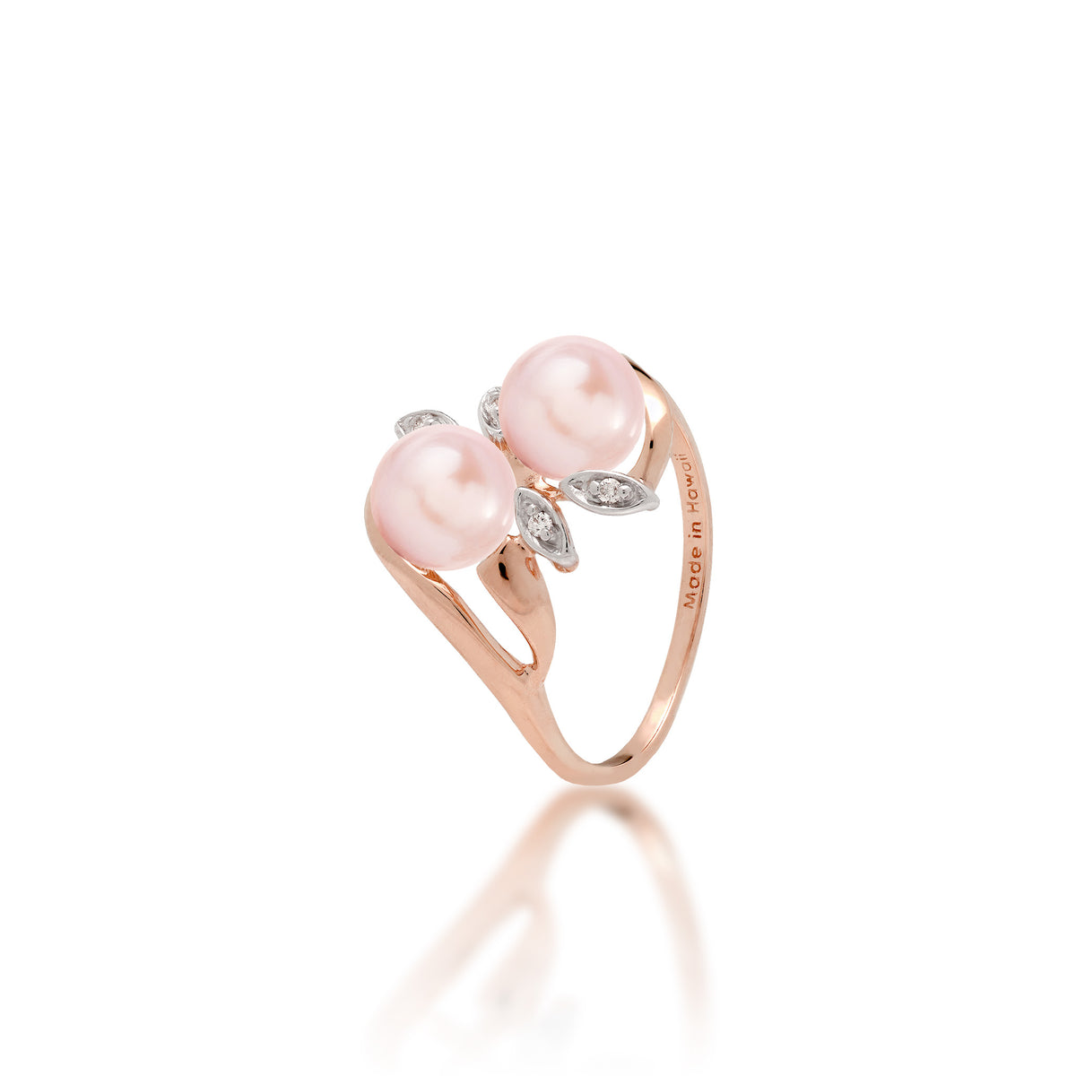 A 14k rose gold ring with two pink freshwater pearls and two diamond accent maile leaves on each side, shown on white background
