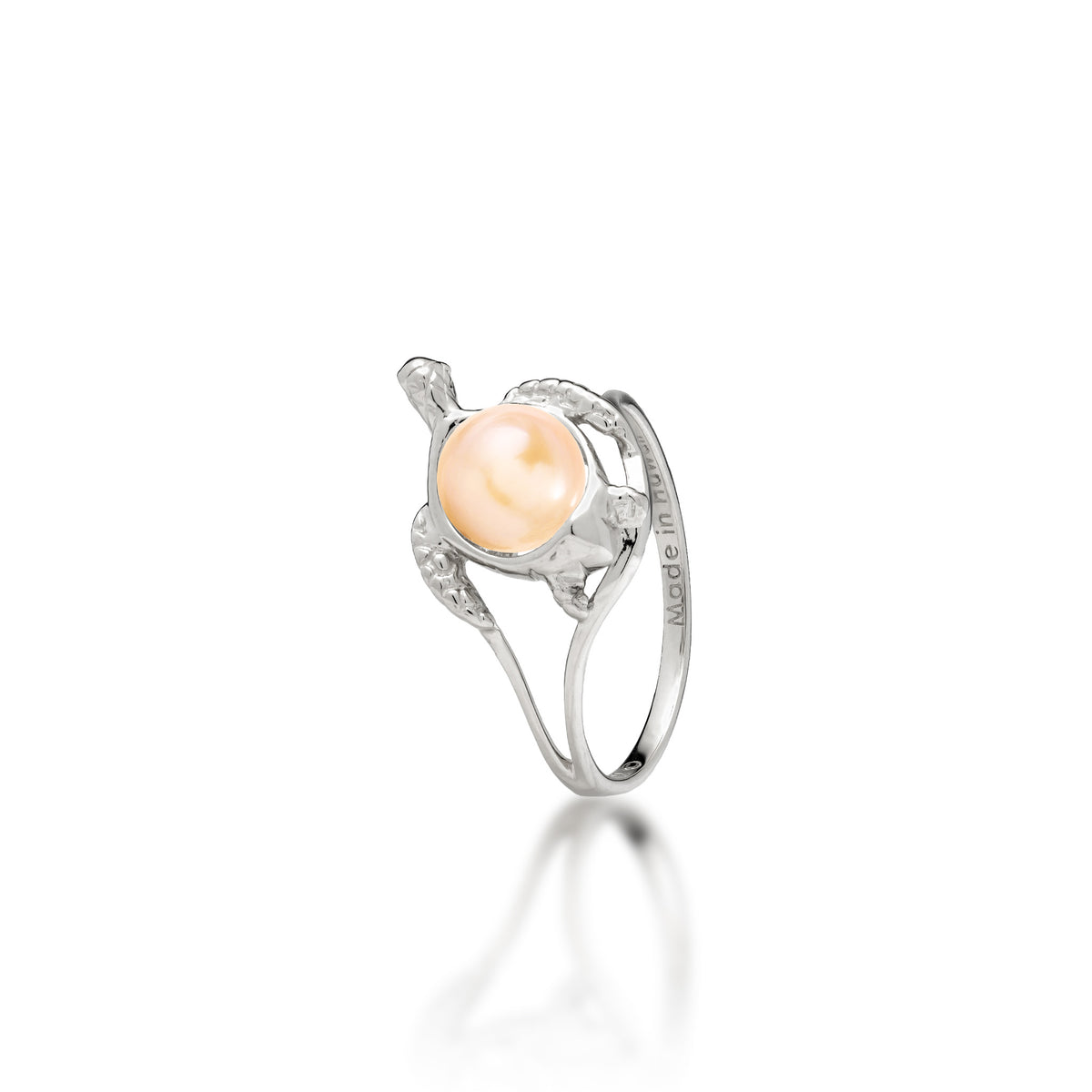 A 14k white gold sea turtle ring with a peach freshwater pearl as its shell, shown on a white background