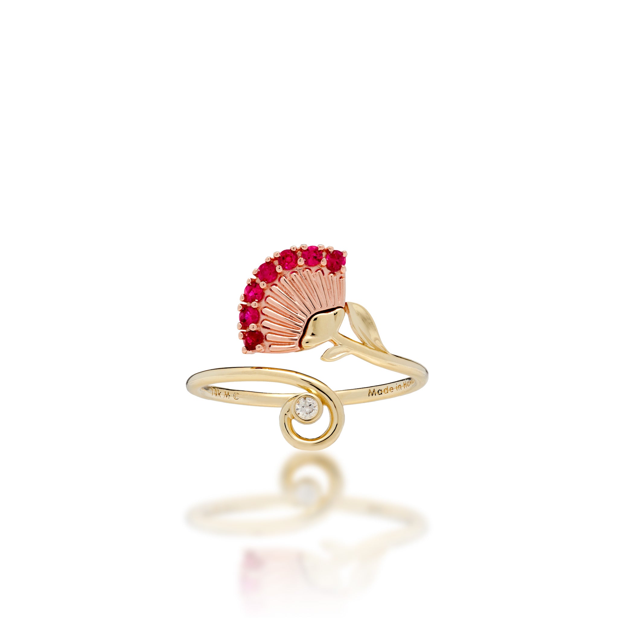 An ʻŌhiʻa Lehua Flower Ring with a 14k Rose gold flower set with red rubies and a high-polish 14k yellow gol dband with a curling end set with a diamond, shown on a white background