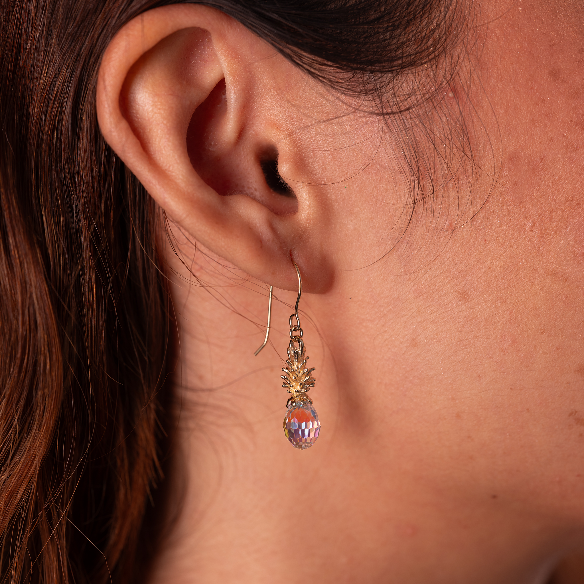 Close up of 20mm Crystal Pineapple Dangle Earrings in Gold on ear