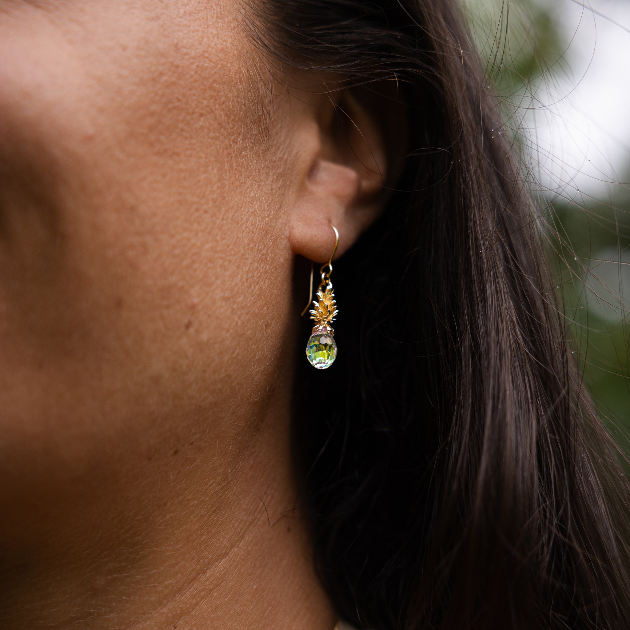 Close up of 20mm Crystal Pineapple Dangle Earrings in Gold on ear