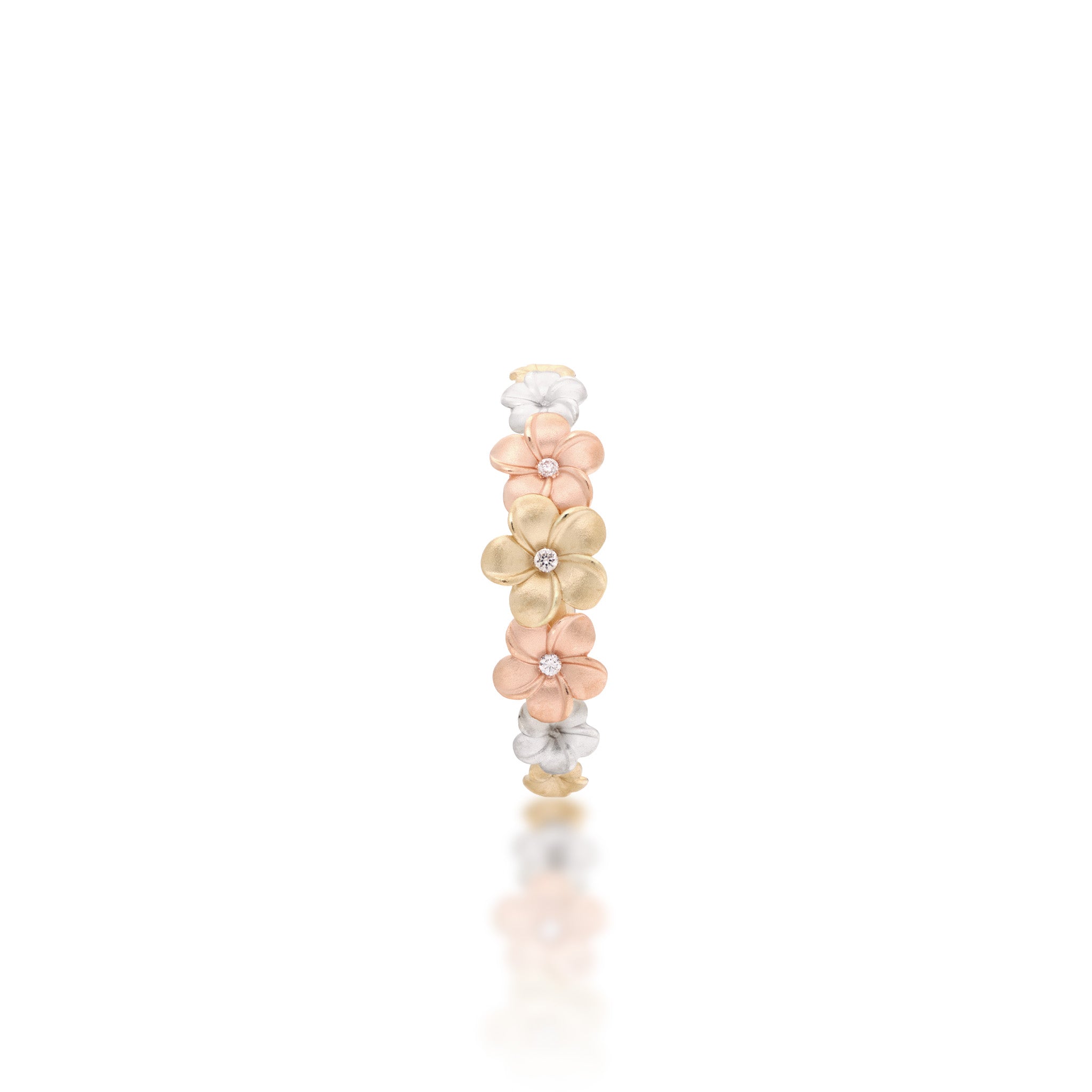 Top view of a Diamond Plumeria Ring in 14k Yellow, Rose, and White Gold on a white background
