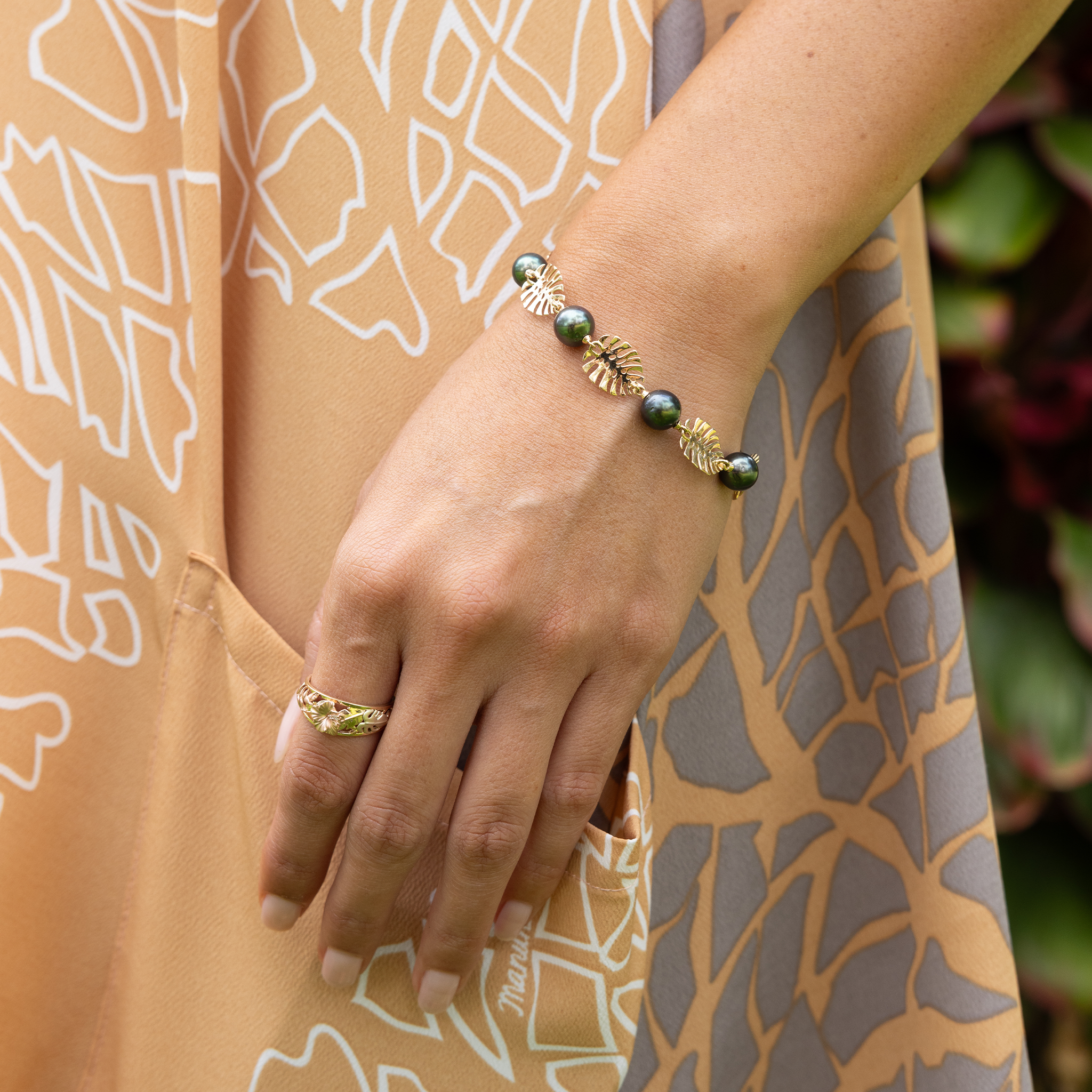 Hawaiian Gardens Hibiscus Ring in 14k Tri Color Gold with Diamonds and Pearl Monstera Bracelet on hand
