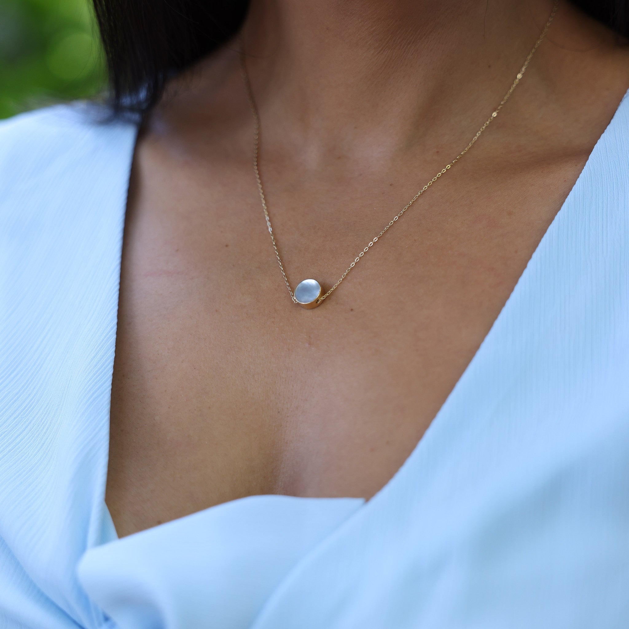 Close up of woman wearing 16-18" Adjustable Eclipse Flipside Black Coral & Mother of Pearl Necklace in Gold - 9mm