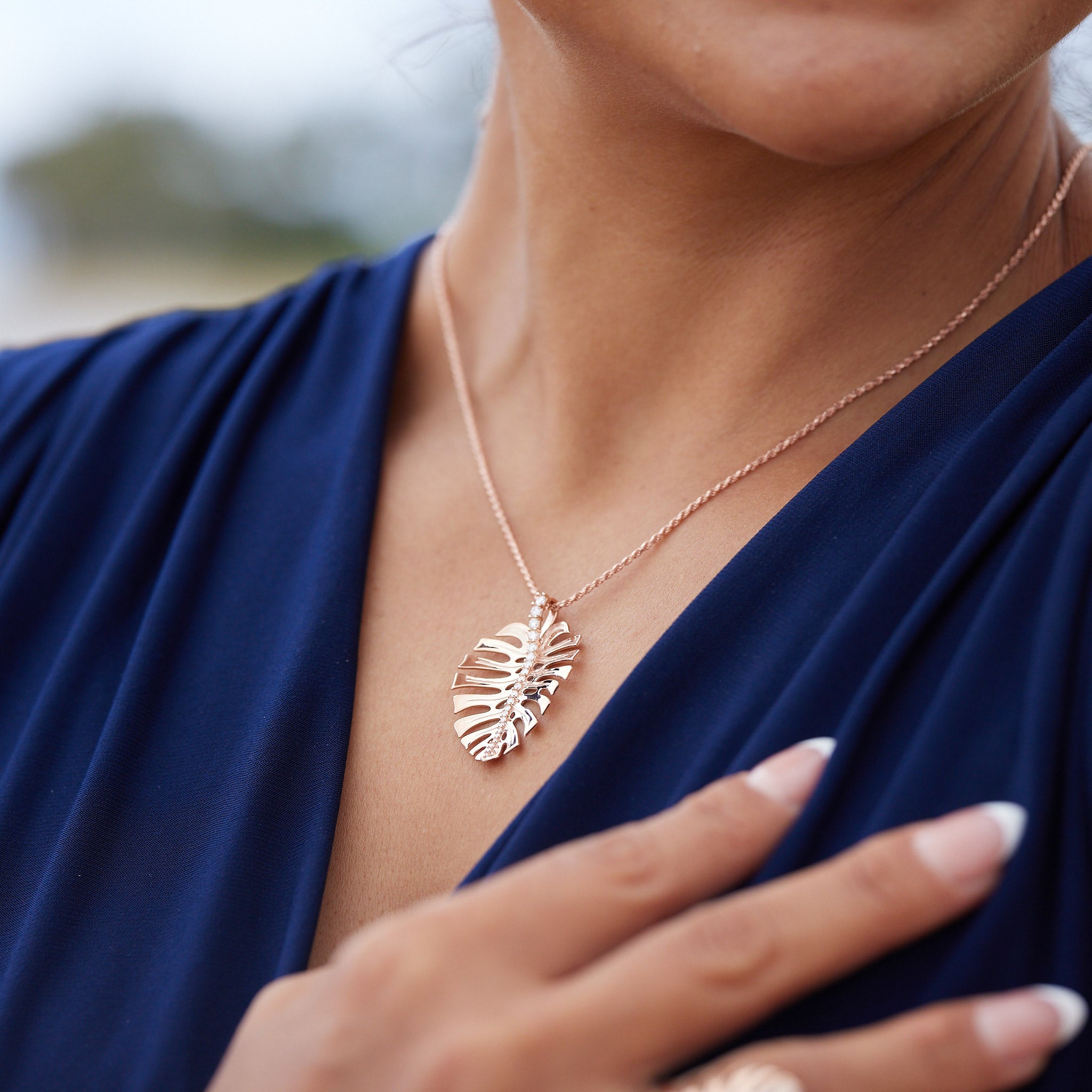 A woman wearing a 18" 1.0mm Flex Rope Chain in Rose Gold with a Monstera Pendant - Maui Divers Jewelry