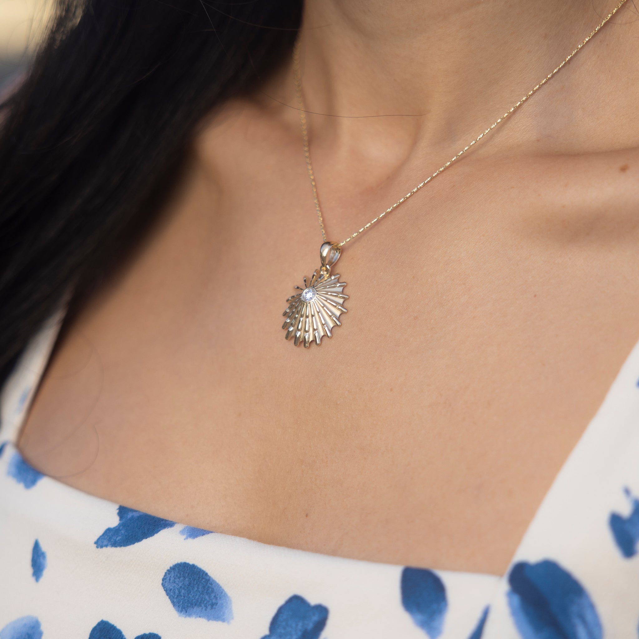 Closse up of a woman wearing an ʻOpihi Pendant in Gold with Lab Grown Diamond