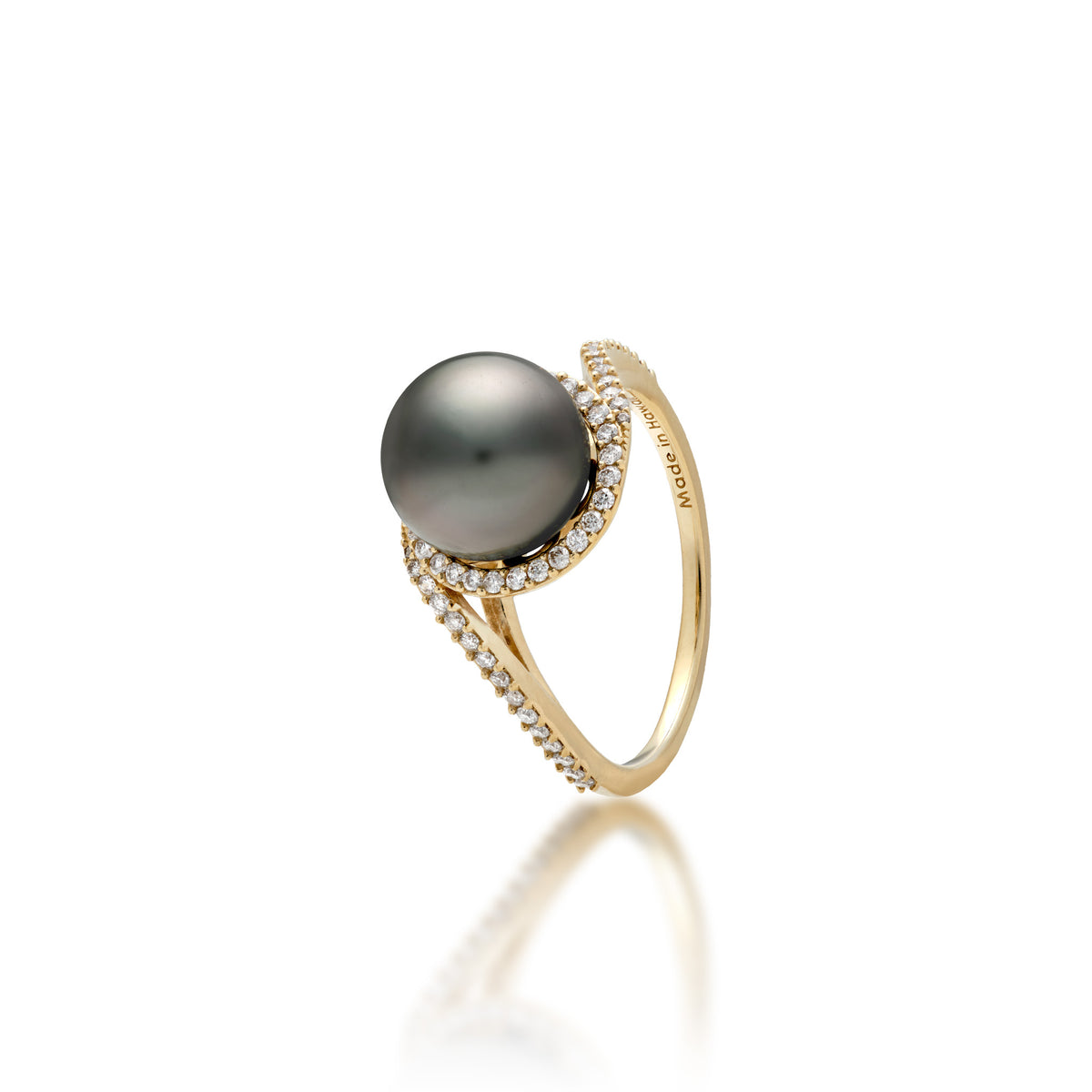 A 14k yellow gold ring with a páve diamond band that curves to the top to form a diamond halo around a Tahitian black pearl, shown on a white background