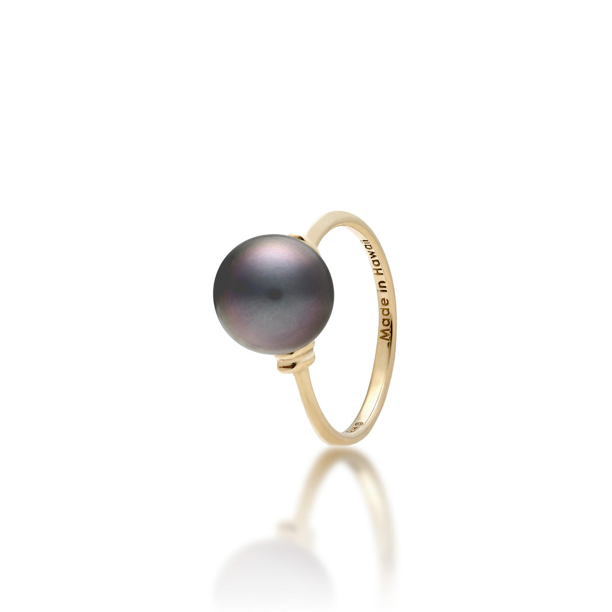 A 14k yellow gold ring with a Tahitian black pearl and raised divot gold accents on each side  of the pearl, shown on a white background