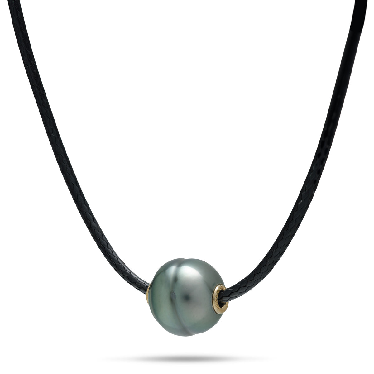 A black cord necklace with a 10-12mm circlé Tahitian black pearl with gold accents on each side, shown on a white background