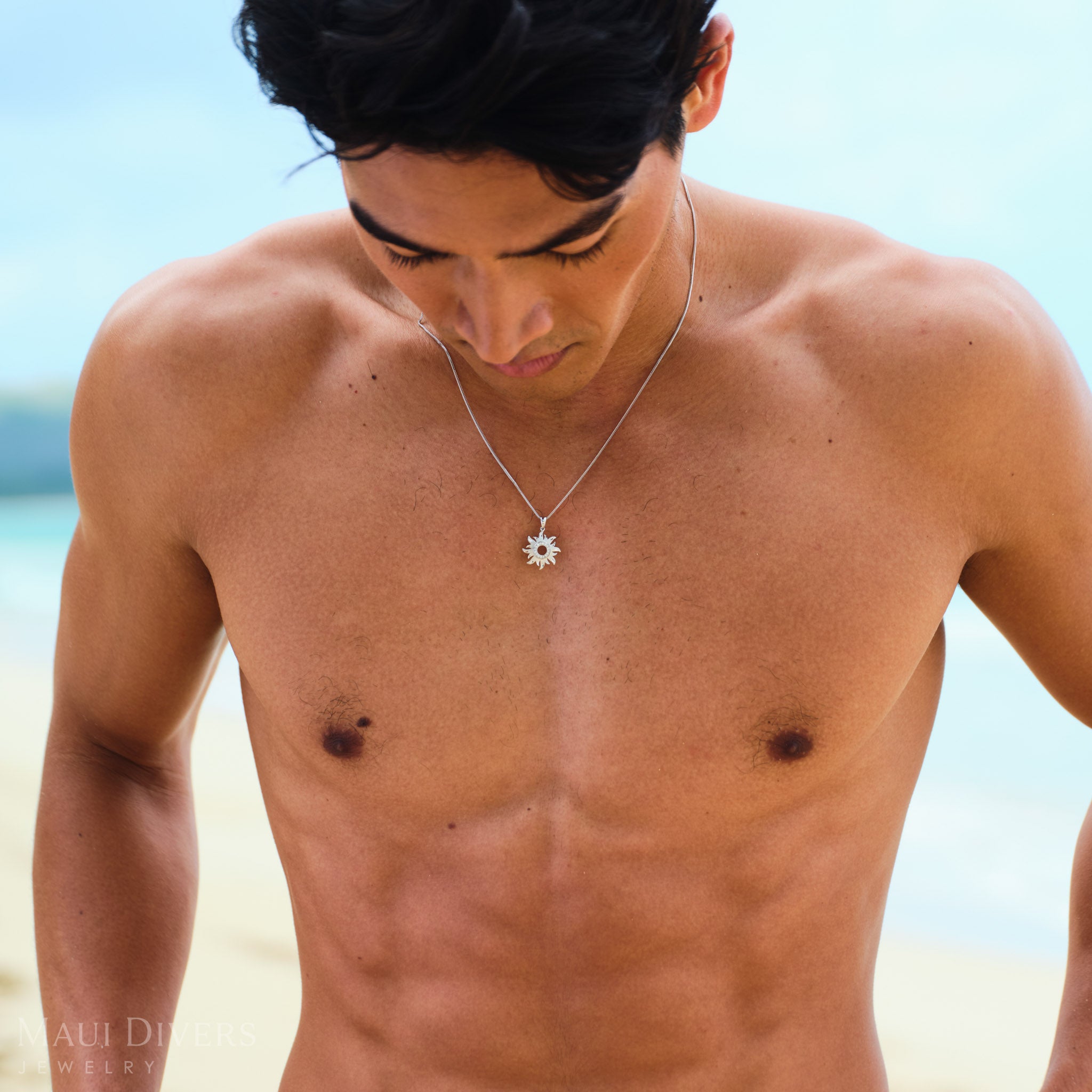 Man wearing a white gold sun pendant