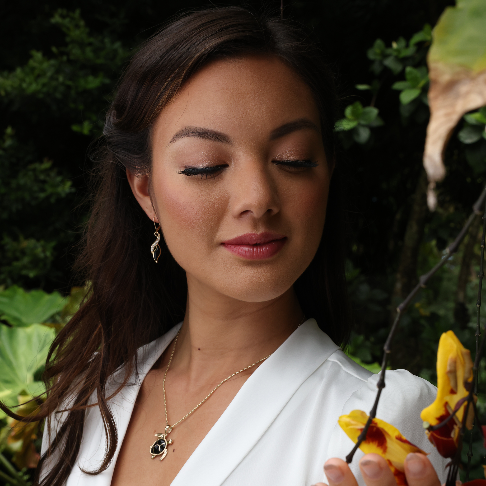 A woman wearing Paradise Black coral Earrings in Gold with Diamonds and a necklace - Maui Divers Jewelry