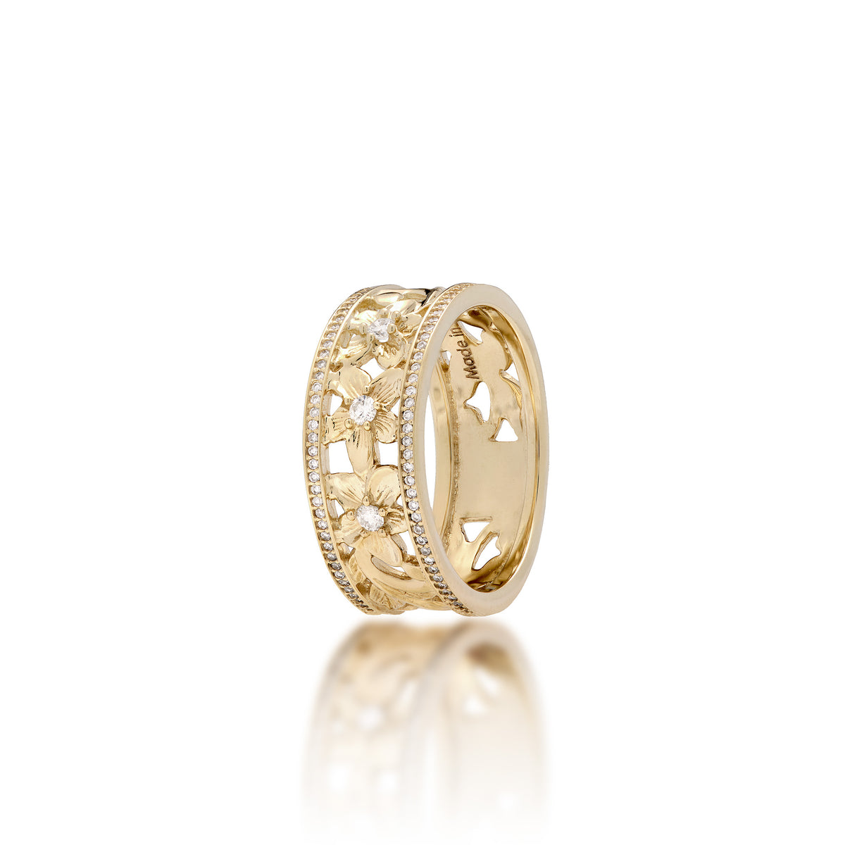 A 14k yellow gold Hawaiian Heirloom ring featuring a row of small pavé-set diamonds on each side of the band and cut-out diamond-accented plumeria flowers at the center, shown on a clean white background with a soft reflection below.
