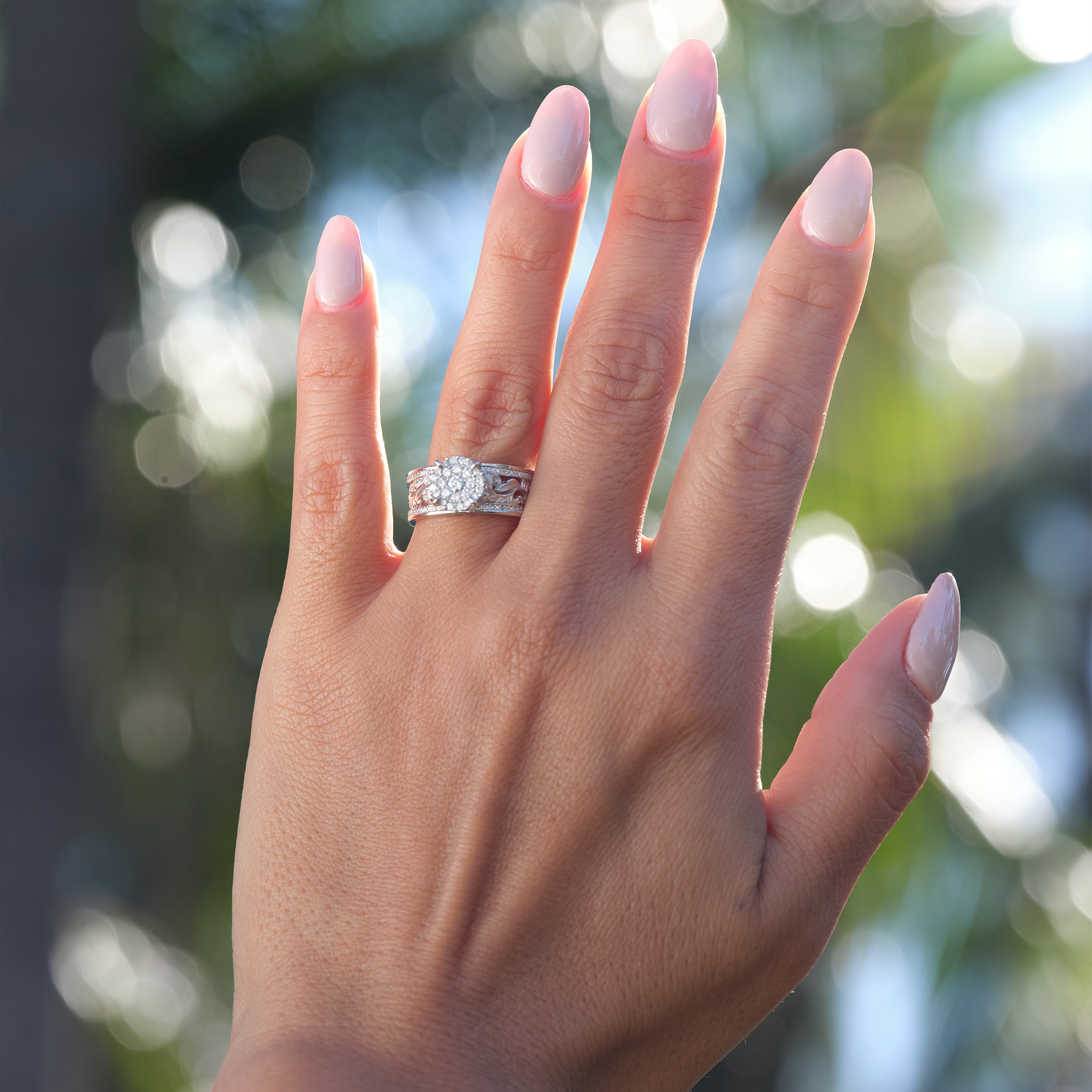 A woman's hand with a Hawaiian Heirloom Engagement Ring in White Gold with Diamonds - 7mm-Maui Divers Jewelry