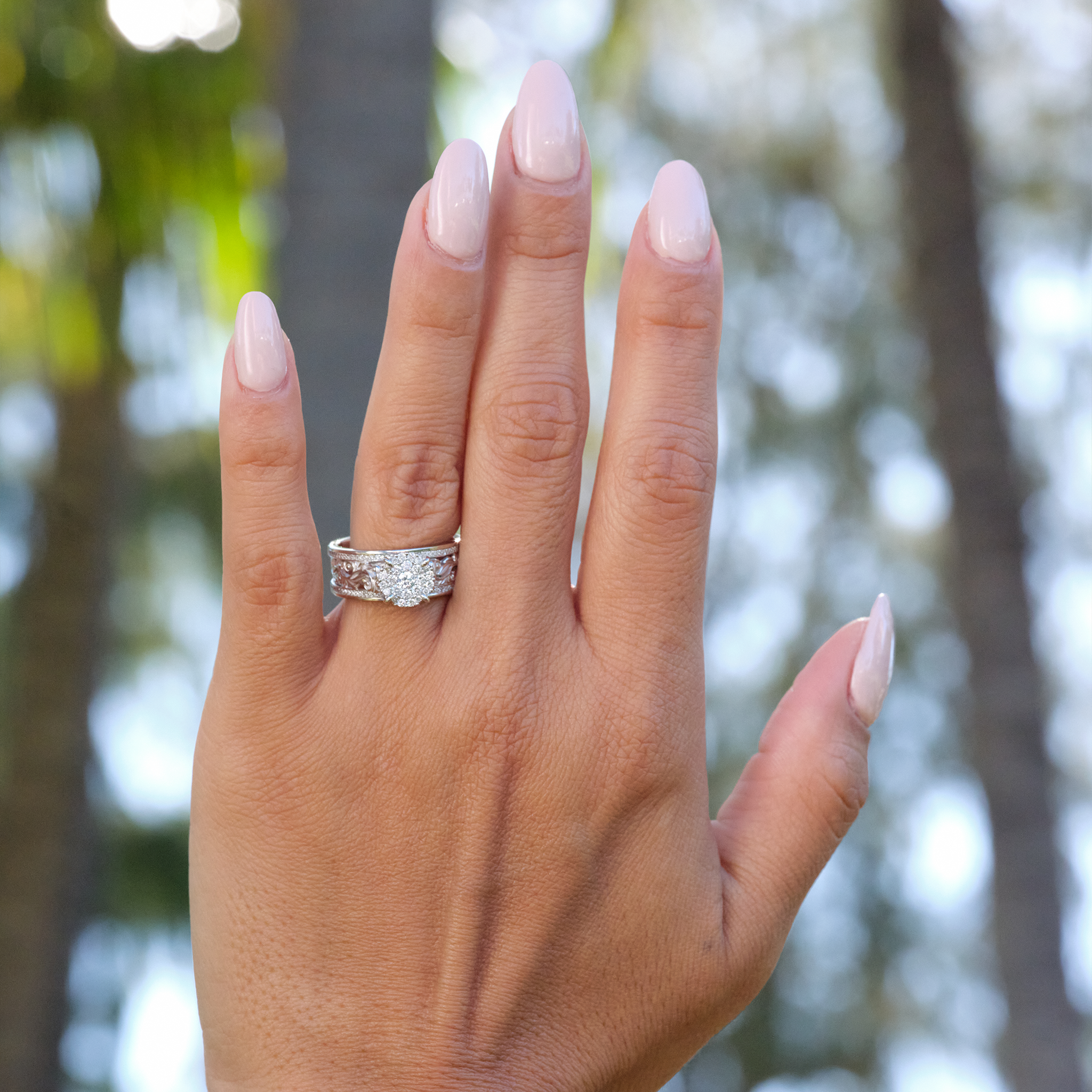 A woman's hand with a Hawaiian Heirloom Engagement Ring in White Gold with Diamonds - 7mm-Maui Divers Jewelry