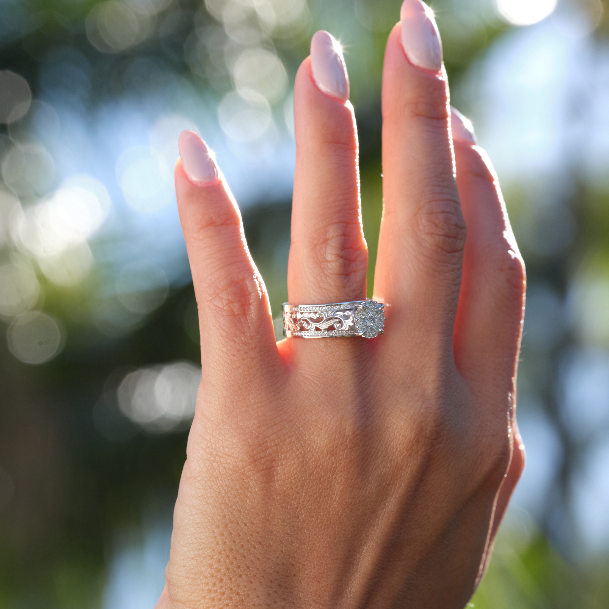 A woman's hand with a Hawaiian Heirloom Engagement Ring in White Gold with Diamonds - 7mm-Maui Divers Jewelry