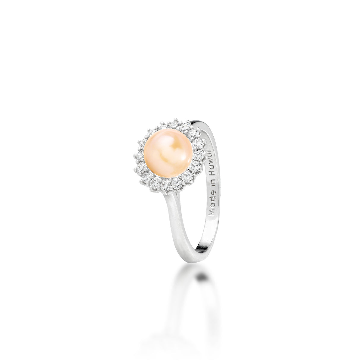 A sterling silver ring with a cubic zirconia halo and peach freshwater pearl at the center, shown on a white background