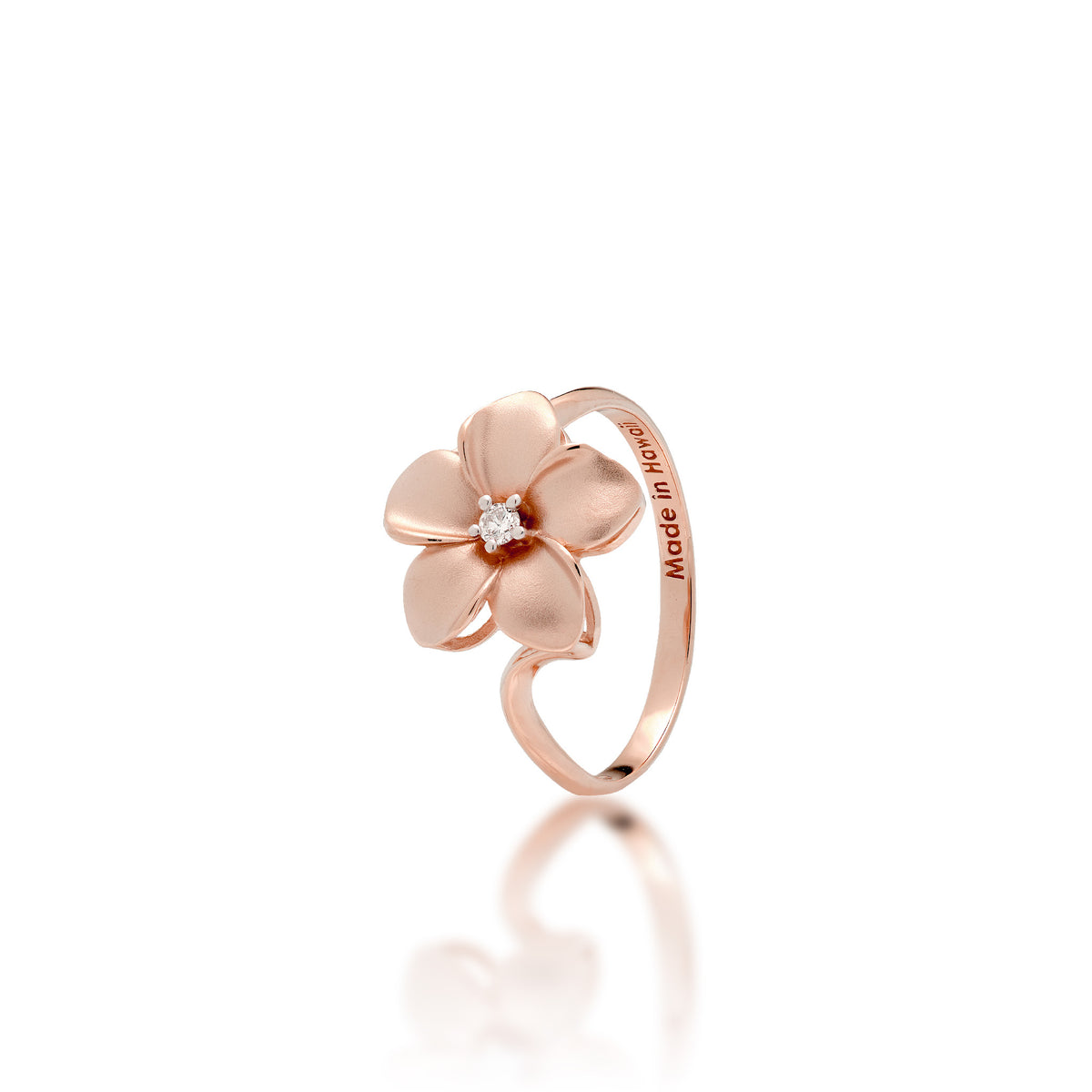 A 14k rose gold 13mm plumeria flower ring with a diamond accent in the center and satin finished petals with high-polish edges, shown on a white background