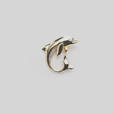 Video of the Ocean Dance Dolphin Pendant in gold with diamonds on a white turn table