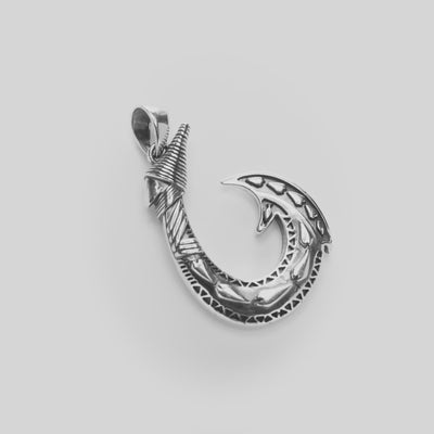 Fish Hook Pendant in Sterling Silver on a white turntable