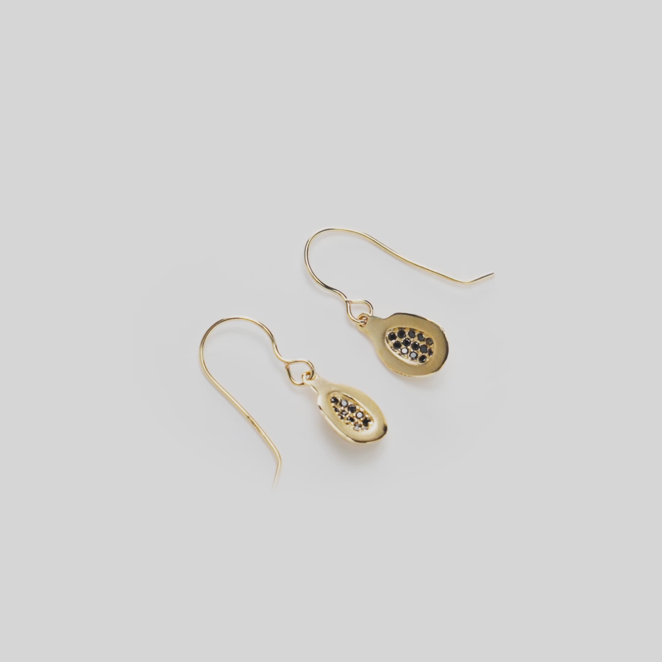 Video of a 13mm Papaya Shepherd's Hook Earrings in 14k Yellow Gold with Black Diamonds on a Rotating White Background