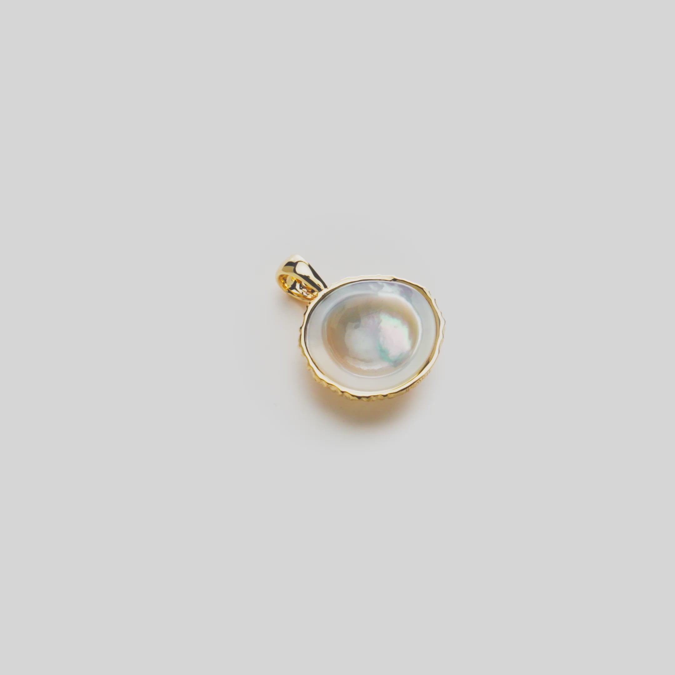 16mm Coconut Pendant with Mother of Pearl Inlay in 14k Yellow Gold on a rotating white background