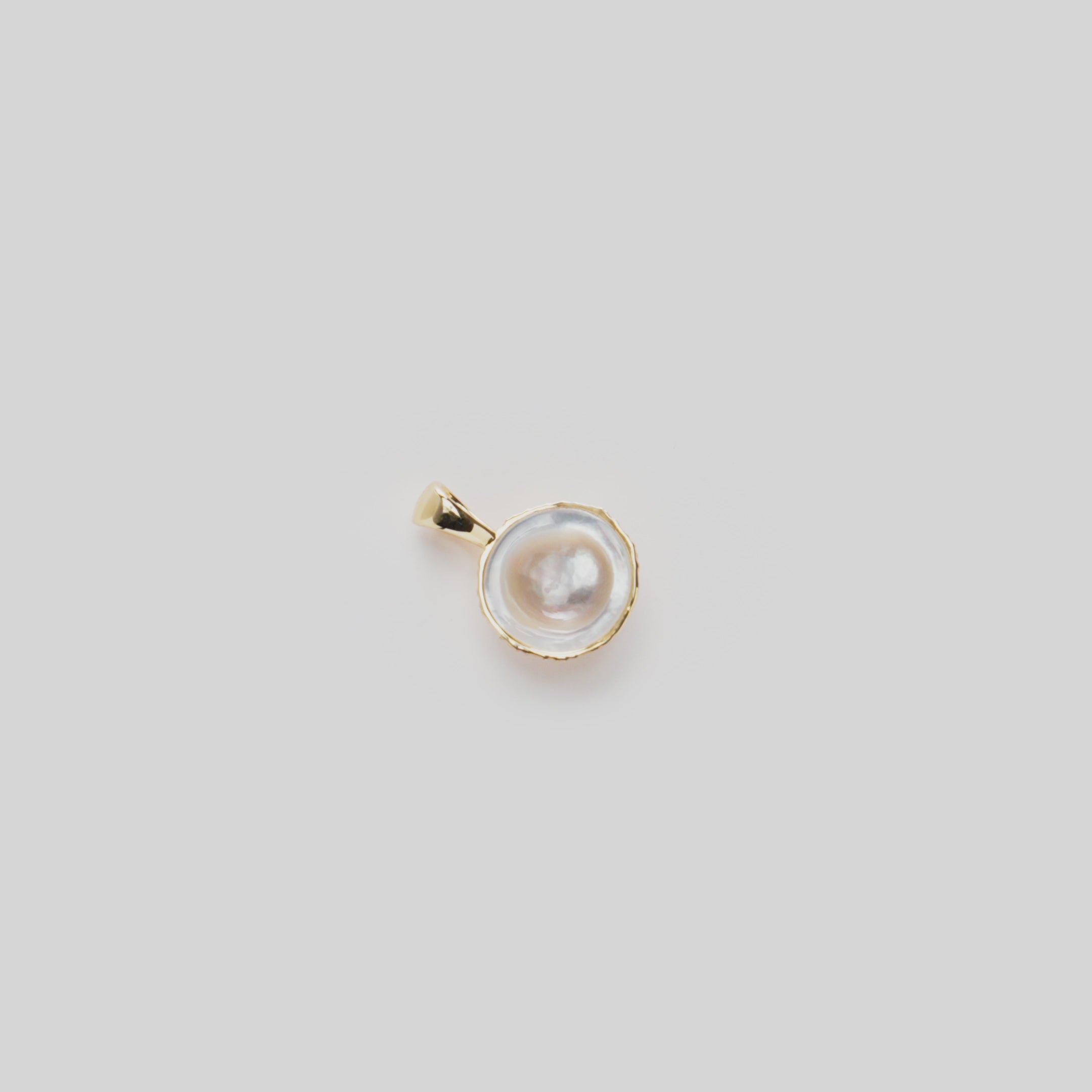 Close-up video of a Cute Fruits Coconut Mother of Pearl Pendant in 14k yellow gold rotating on a white background