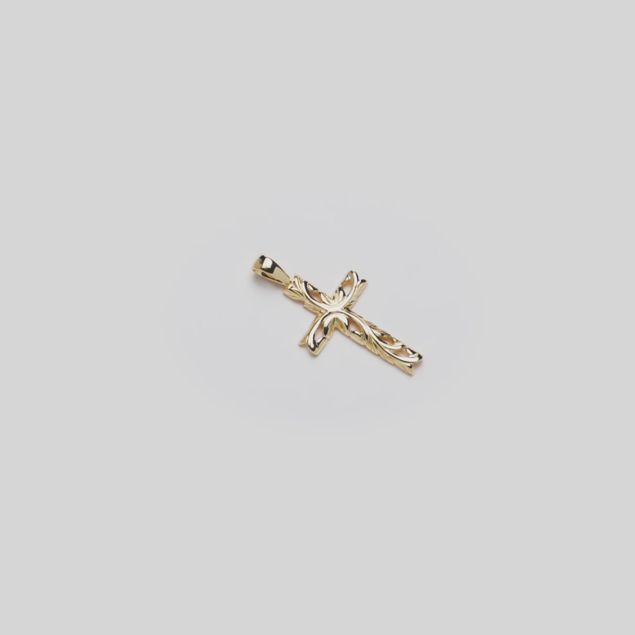 Video of the 24mm Hawaiian Heirloom Old English Scroll Cross Pendant in 14k Yellow Gold turning on a white background
