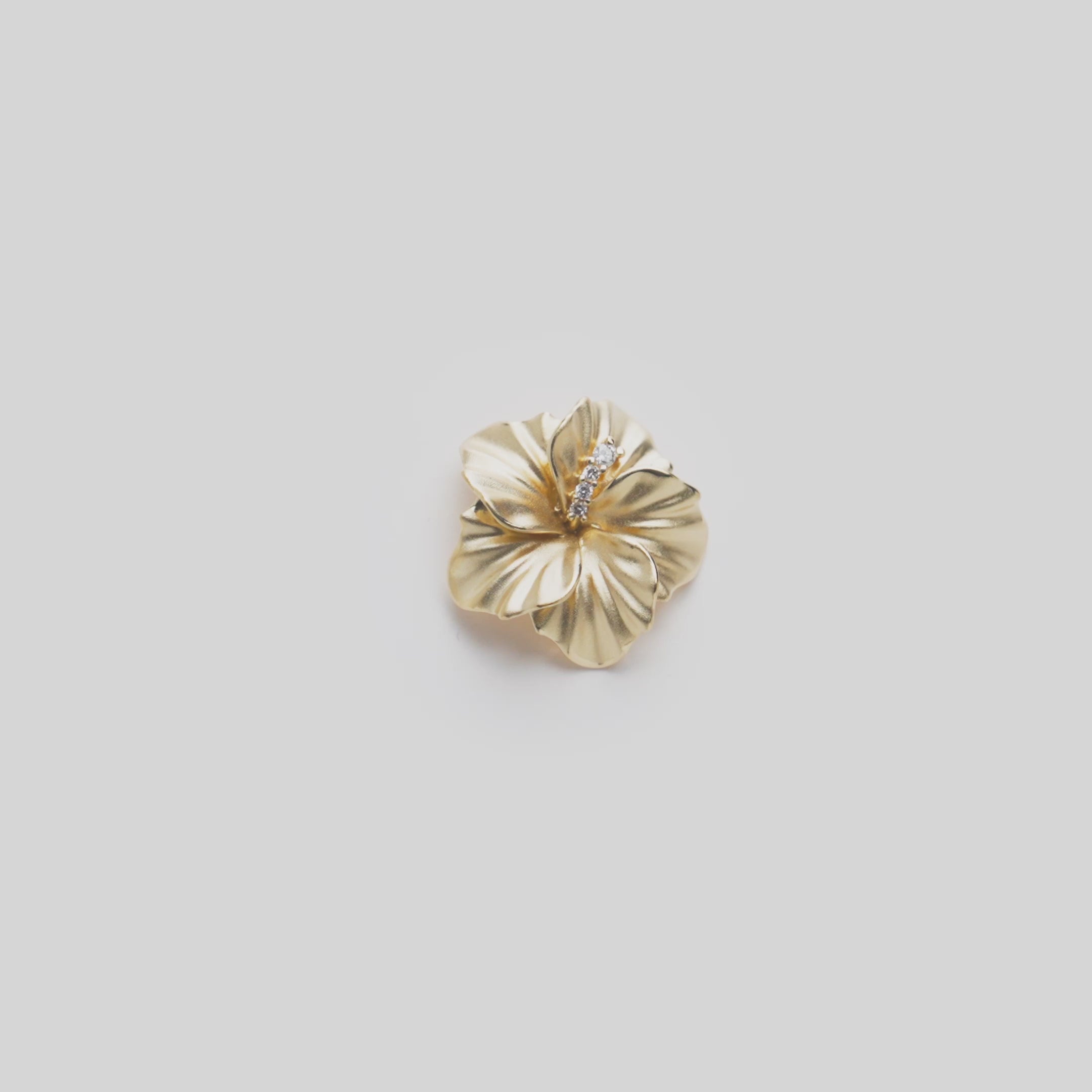 Video showcasing the 15mm Diamond Hibiscus Pendant in 14k Yellow Gold on a white background