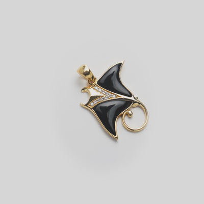 Sealife Manta Ray Black Coral Pendant in Gold with Diamonds on a white turntable