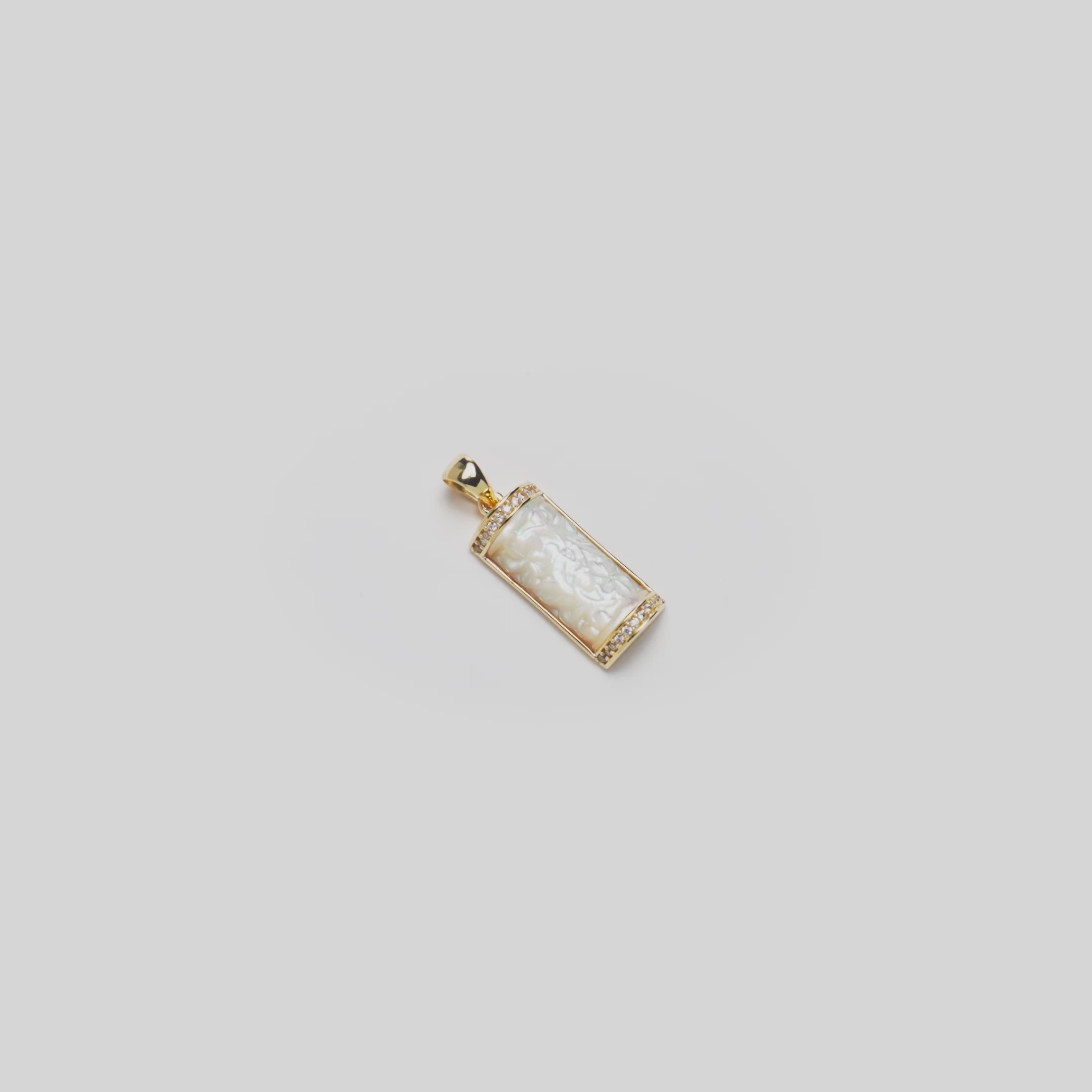 Video of the 17mm Hawaiian Heirloom Plumeria Mother of Pearl Pendant in 14k Yellow Gold turning on a white background