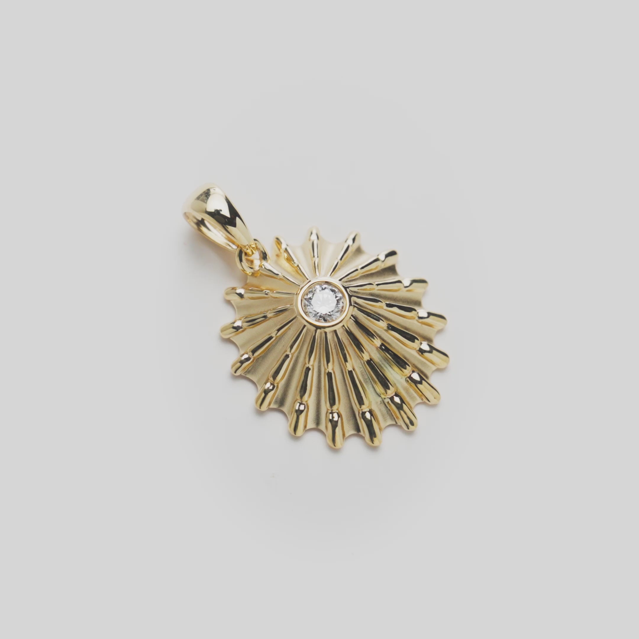 Close up video of an  ʻOpihi Pendant in Gold with Lab Grown Diamond on white turn table
