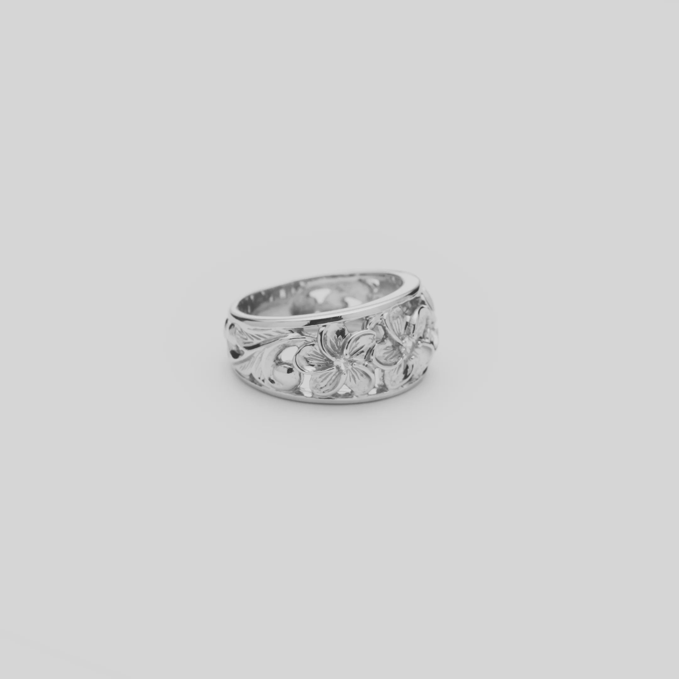 Video of the 11mm Hawaiian Heirloom Plumeria White Sapphire Ring in Sterling Silver turning on a white background