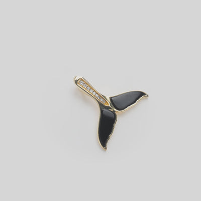 Close up video of Sealife Whale Tail Black Coral Pendant in Gold with Diamonds on white turn table