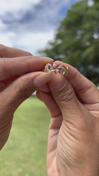 Video of a woman's hand wearing a Hawaiian Heirloom Plumeria Ring in Two Tone Gold with Diamonds - 8mm - Maui Divers Jewelry